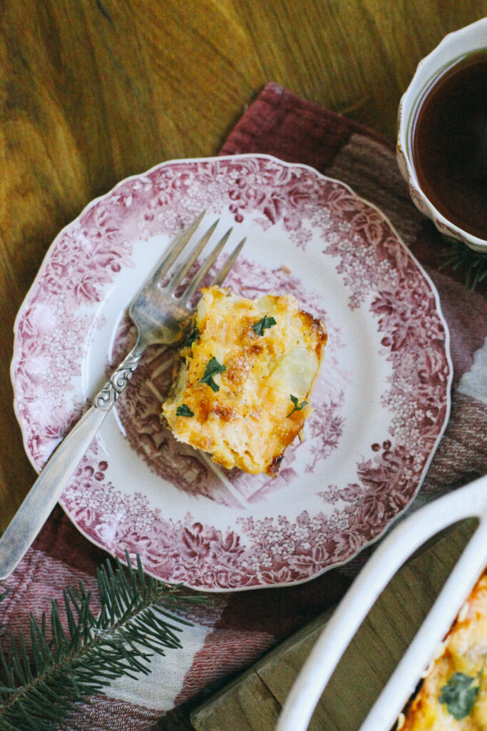 Photo of a slice of breakfast casserole on christmas dishes