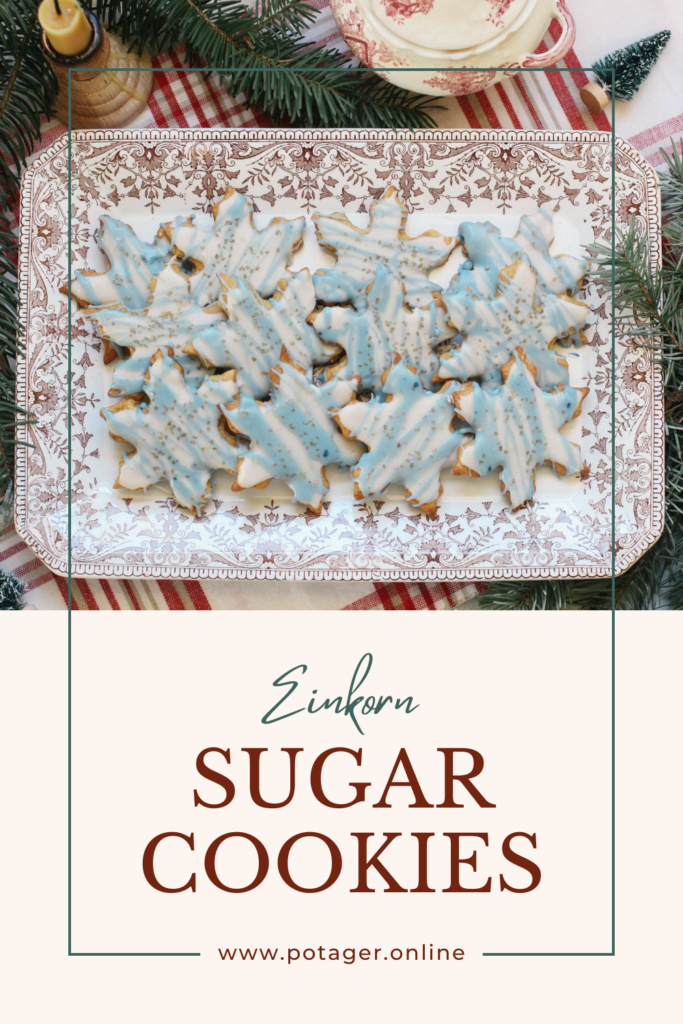 Photo of a platter of Einkorn Christmas Sugar Cookies frosted with blue and white frosting and gold sprinkles