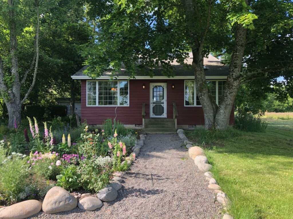 Photo of Swedish Cottage with one half of the landscape completed.