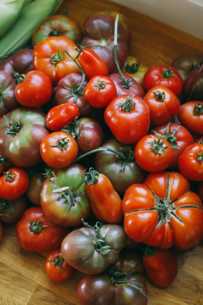 Photo of a pile of heirloom tomatoes on a wooden butcher block counter