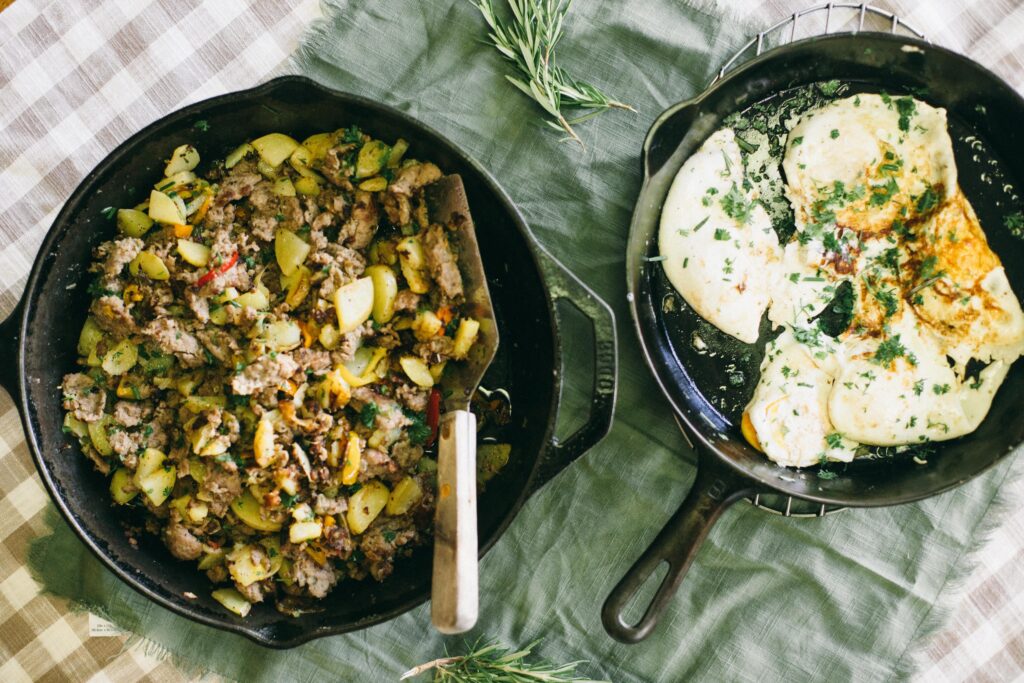 Image of two cast iron pans with a Breakfast Skillet and Fried Eggs