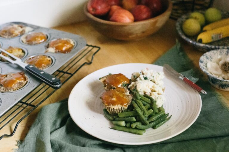 Image of a plate of meatloaf muffins, garden green beans and mashed potatoes