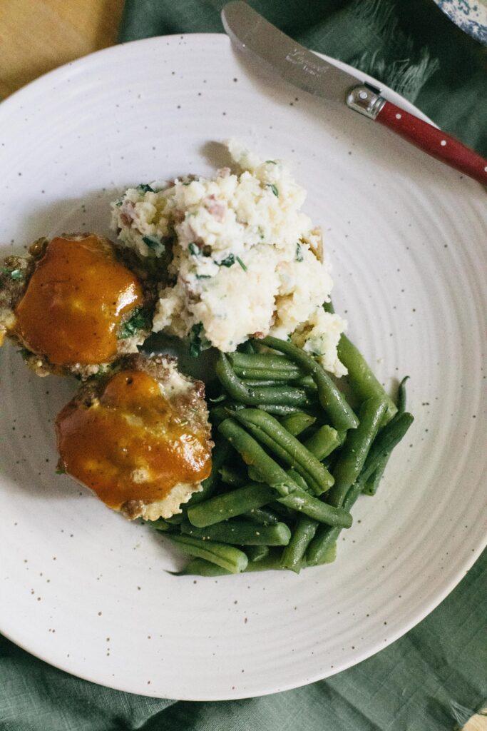 Image of a plate of Meatloaf Muffins, Mashed potatoes and garden green beans