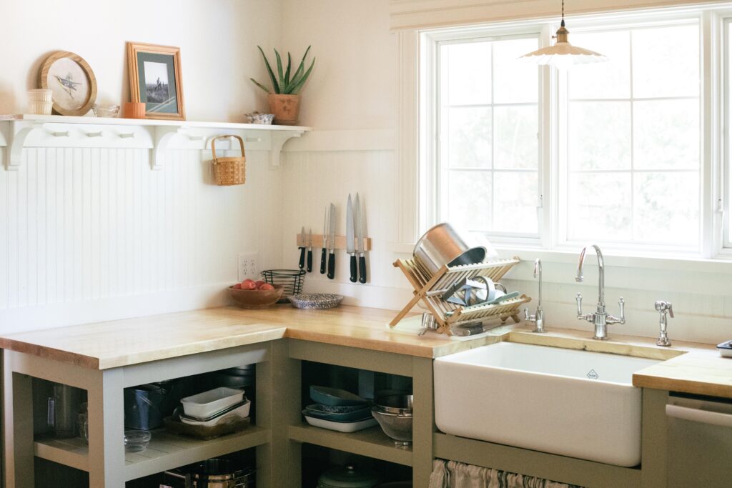 Image of a country unfitted kitchen farmhouse sink and open shelving