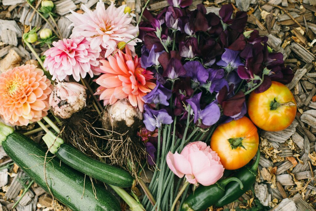 Image of garden bounty laid out on a wood path in a potager garden