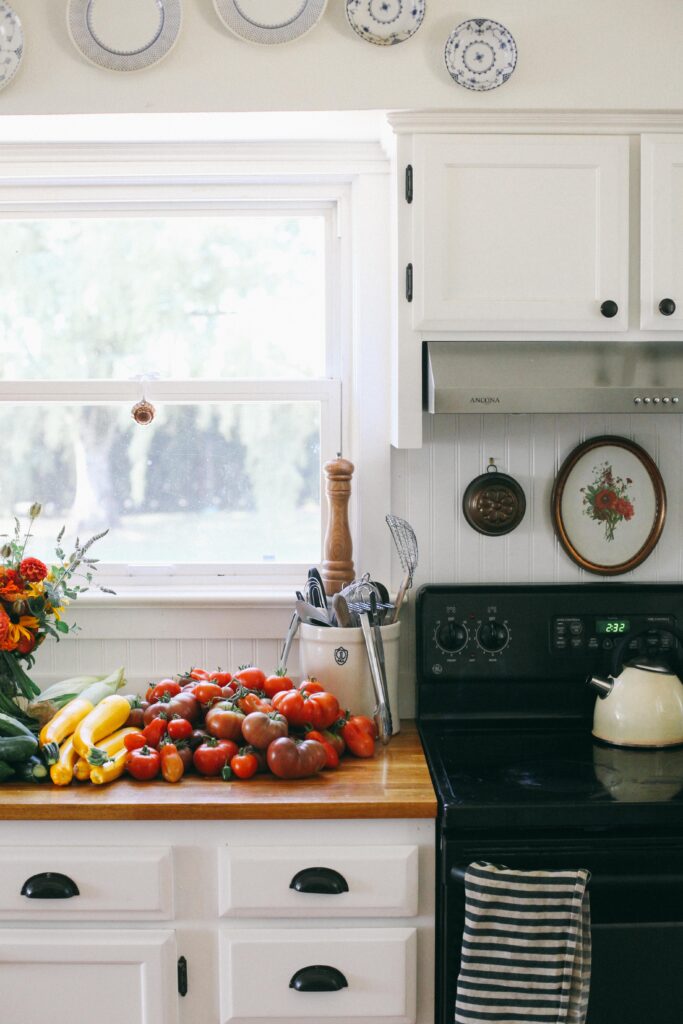 Image of garden veggies on a butcher block countertop in a farmhouse white kitchen