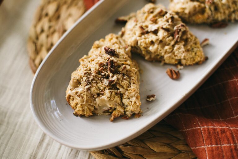 Image of Einkorn Maple Pecan Scones on a white platter with burnt orange tablecloth