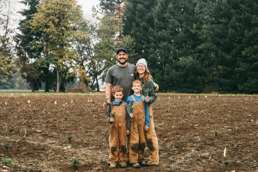 A photo of a family after planting a field of Christmas Trees on their farm homestead