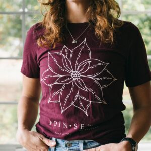 Image of a woman wearing a Potager Online Poinsettia Gardening Tee