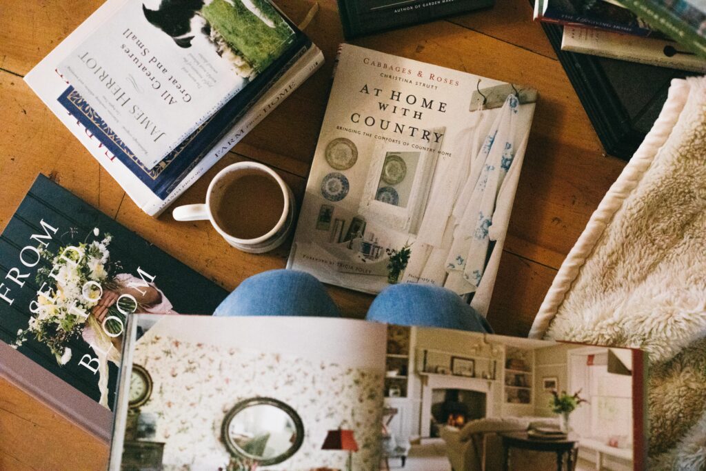 Image of a woman on her knees with books on her lap and all around